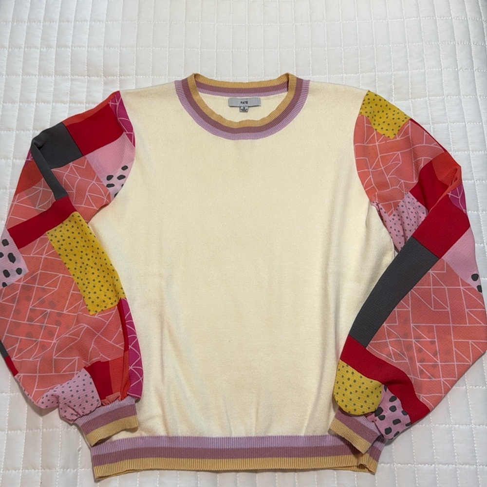 Women’s cream sweater with color block sleeves